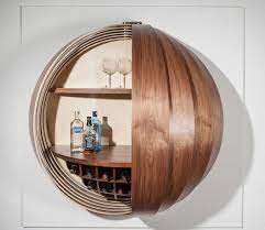 Have you ever seen a home bar that was quite so cool? A Wall Mounted Bar Cabinet Inspired By A Spinning Coin