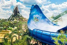 A Group In A Raft Slides Up The Sweeping Side Of The Honu Water Slide At Universal S Volcano Bay Disney World Hotels Universal Orlando Resort Volcano Bay