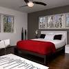 The wall behind the bed is a deep grey which does well with a bit of brightness injected into it. 1