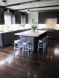 Cozy kitchen featuring mixture of wood tones, from light natural flooring, to dark cherry cupboards, to black stained island, with marble countertops throughout. Cococozy Exclusive Kitchen Couture An Elegant California Classic Cococozy Wood Floor Kitchen Painted Kitchen Cabinets Colors Grey Kitchen Cabinets