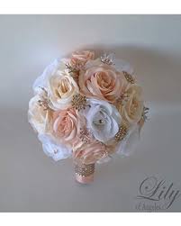 Look for a mix of flowers like mums, lilies, roses, and bells of ireland. Bridesmaid Bouquet Champagne Bridal Bouquet Wedding Bouquet Wedding Flower Silk Flower Bouquet Beige Ivory White Lily Of Angeles Bouquets Bouquets Corsages