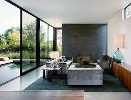 This contemporary kitchen offers an open concept with breakfast bar island adjacent to the living room with a sectional couch. Dashing Room Combines Industrial And Minimalist Styles Decoist Minimalism Interior Minimalist Living Room Minimalist Living Room Design