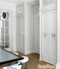 A small l shaped eat in kitchen with oak cabinetry, basic appliances, and a green tile back splash to the ceiling. Small Elegant Apartment Chic Small Spaces