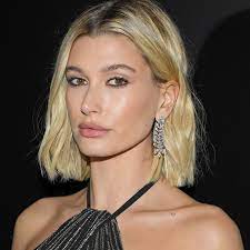 Hailey rocked strappy heels with a tan halter wrap dress, with her hair in a tight bun. Hailey Bieber S New Bronde Hair Is The Prettiest Way To Avoid Root Regrowth Glamour