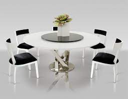 Interior of modern kitchen with white and beige tile walls, wooden floor, gray countertops and cupboards and dining table. A X Spiral Modern Round White Dining Table With Lazy Susan
