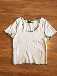 Black And White Brandy Melville Shirt Brandy Melville Mckenna Top Has Black Contrast Stitching Around The Lettuce Hemming Of The Shirt It Also Has A Swooping Tops Brandy Melville T Shirts Shirts