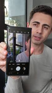 This is genius. It lets you conveniently take photos if your phone screen  is super large.