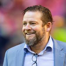 How Seahawks GM John Schneider Ended Up Topless Sporting WWE Belt