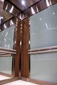 The Rear Wall Of This Elevator Interior Is Fitted With Back Painted Safety Glass Above And Below The Elevator Design Elevator Interior Elevator Interior Design