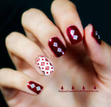 red snowflakes on white accent nail art