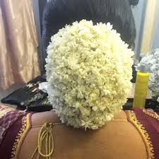 What A Beautiful Large Low Bun Covered With Real Flowers Care However Should Be Taken Before Wedding Bun Hairstyles Wedding Hair Inspiration Bridal Hair Buns