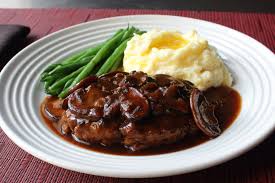 Place a mound of garlic mashed potatoes on a plate, top with hamburger steak and plenty of gravy. Hamburger Steak With Onions And Gravy Recipe Allrecipes