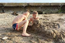 Village boys take a summer swim in a village pond. Kid Fills His Brother With Sand On Beach Of Sea Of Azov Stock Photo Picture And Royalty Free Image Image 130444846