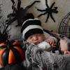 Cute baby boy choosing fall pumpkins an autumn scene with bright orange colors, a 1 year old boys sweater matching the ripe harvested pumpkins on the ground. 3
