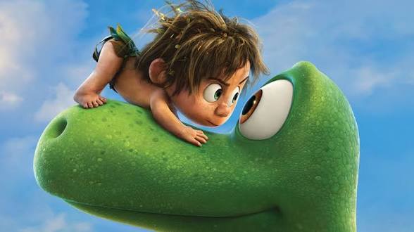 Den gode dinosaurien öga mot öga med den vilda pojken med rufsigt hår