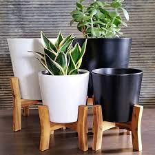 From short to tall, shop the best planters on legs and plant pots with legs. Just Standing Around Looking Pretty Our Jayda Pot Comes Complete With A Wooden Plant Stand To Take Your Potted Des Wooden Plant Stands Blue Garden Garden View