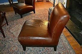 A Matching Pair Of Leather And Wood Armless Chairs By Chair Armless Chair Recliner Chair
