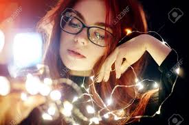 Mini lights give you the opportunity to use your imagination when creating that outdoor holiday display or personalized indoor christmas decorations. Art Portrait Of A Woman With Red Hair In Christmas Lights Girl Stock Photo Picture And Royalty Free Image Image 89704340