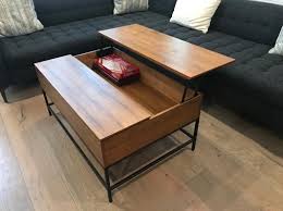 Brown/black medium rectangle wood coffee table with lift top. Hollis Lift Top Coffee Table Living Spaces