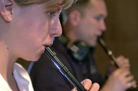 AIRMAN First Class (A1C) Carolyn Gill, USAF, and Technical Sergeant (TSGT) Scott  Gunn, USAF, US Air Force Reserve Pipe Band members create an over-dub  during a recording session held at the Skagg's