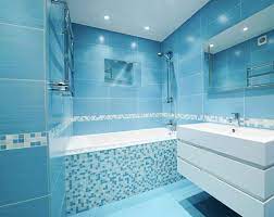 Stunning bathroom features a sky blue double washstand topped with white marble fitted with his and her oval sinks and hook and spout faucets under white beveled mirrors illuminated by polished nickel sconces alongside a carrera marble hex tiled floor. 23 Blue Tile Design Ideas For Your Kitchen Bath Sebring Design Build