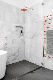 A solid surface bath and basin gives a modern feel and mirrored panelled cabinets provides confined storage which visually expands the space. 18 Gorgeous Marble Bathrooms With Brass Gold Fixtures
