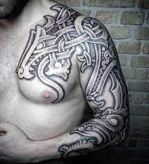 Tribal aztec tattoo design on chest and arm. 50 Tribal Chest Tattoos For Men Masculine Design Ideas