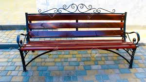 Maybe you would like to learn more about one of these? A Wrought Iron Bench Near The House And A Flower Bed With Flowers Nearby Stock Photo Picture And Royalty Free Image Image 153760230