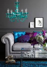 In the center is a silver arrow pendant and below hanging from brown suede is a antique silver plated indian chief pendant with headdress. All Grey Living Room Turquoise Chandelier Vintage Clock Blue Shag Carpet Purple Accent Pillows Shop Room Ideas Interior Design Decorating Shop Room Ideas