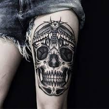 Black And Grey Skull Tattoo On Left Thigh