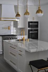White Kitchen With Gold Accents Contemporary Kitchen Kitchen Remodel Gold Kitchen Kitchen Range Hood
