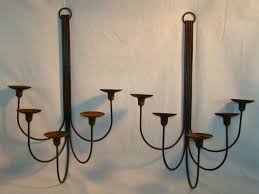 The strength and beauty of wrought iron makes it one of the most popular materials used to accent rustic or southwest decor. Wrought Iron Candle Wall Sconces Primitive Rustic Wrought Iron Old Castle Garden Candle Wall Sconce Candle Wall Sconces Sconces Wall Sconces