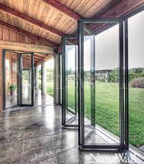 This fireplace door surface mounts outside the fireplace opening, features: Large Glass Folding Doors For A Seamless Transition To The Outside Diseno Para El Hogar Puertas Corredizas De Vidrio Arquitectura