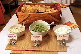 Kick it up a notch with flower or tissue pom poms hanging from tree limbs. A Mexican Buffet Dinner Party