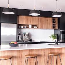 A kitchen that opens up into the main living area can be an extremely exciting space to decorate. Homes To Love Nz On Instagram Black White And An Accent Of Warm Wooden Look Cabinets This Kitchen Design Interior Design Kitchen Modern Kitchen Design