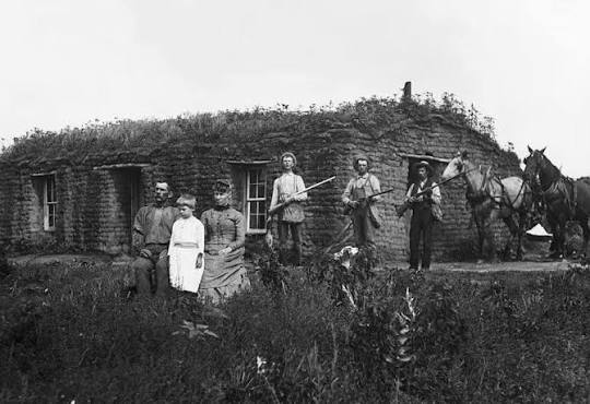 A family in front of their sod house in Custer County, Nebraska, 1887.
