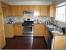 Dark Maple Cabinets With White Countertops
