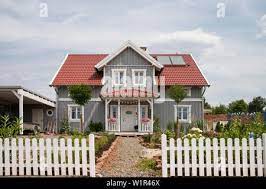 Gray two-story single family house with one dormer and a red roof in Nordic  style with wooden facade, Korbach, Hesse, Germany, Europe Stock Photo -  Alamy