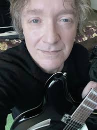 I'm playing the Martin D-28. I've been switching between the Martin, the  Guild Jumbo 6-string, and the Guild Jumbo 12-string tonight. They all sound  radically different! What are Gibson acoustics like to