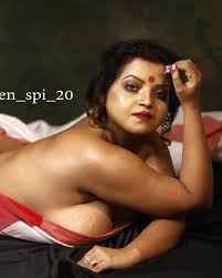 Bindu aka Shilpi Das lies on her stomach and shows her big side boobs in a  braless white saree
