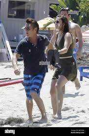 EXCLUSIVE!! Actor Sean Penn chases a paparazzo off the beach while being  held back by new girlfriend Stacey Koplin during the Fourth of July  holiday. Penn, who is no stranger to scuffles