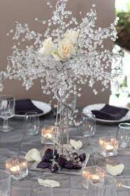 The Table Centerpiece For New Years Eve With Crystal Tree And White Flowers Wedding Table Wedding Centerpieces Wedding Decorations