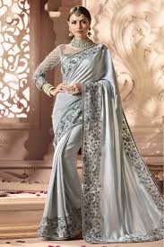 If you have a plain cotton saree, you can accentuate the look by using a large silver necklace. Barfi Silk Designer Saree In Silver Colour