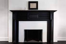 This natural stone surround makes an impressive visual display, moving right up to the sloped ceiling, and drawing the eye upward to emphasize the height and shape of the room. Black Fireplace Mantle Design Ideas