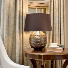 Keep a contemporary look in the living room with sleek, geometric table lamps. Elstead Lighting Caesar 1 Light Table Lamp Gold