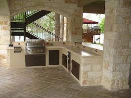 This outdoor kitchen set on a deck offers a barbecue grill and a bar with a marble countertop. Build Brick Outdoor Kitchen Install Outdoor Kitchen Island Outside Grilling Island