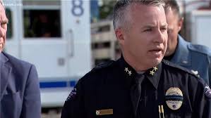 John garrod, of arvada, stands holding a blue line flag at the beginning of a line of about 30 police cars lined up for a procession in honor of the officer who was fatally shot in arvada, colo. Wovbzydffcwqgm