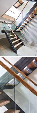 Wood And Stone Cover The Exterior Of This Multi Level Modern House In The Forest Glass Stairs Floating Stairs Glass Staircase