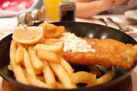 The Fish And Chips Are Served With A Simple Lemon Slice And Are Essential Fish And Chips British Food Food