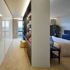 Elegant bedroom with walk in closet behind stylish, black and mirrored wall. Cheyne Terrace Chelsea London Wardrobes Walk In Wardrobes And Furnishings By Lema For T Wardrobe Behind Bed Master Bedroom Furniture Master Bedroom Plans